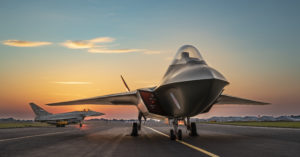 The Tempest concept model, a vision of the UK's combat air future, sits alongside a Eurofighter Typhoon on the runway at BAE Systems site in Warton, Lancashire.